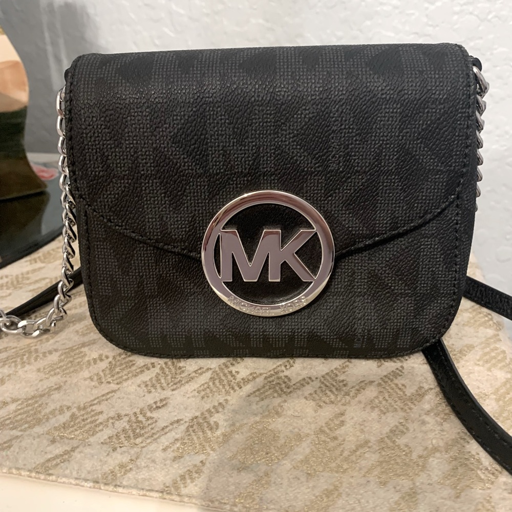 Black Michael Kors crossbody bag with silver and black handle